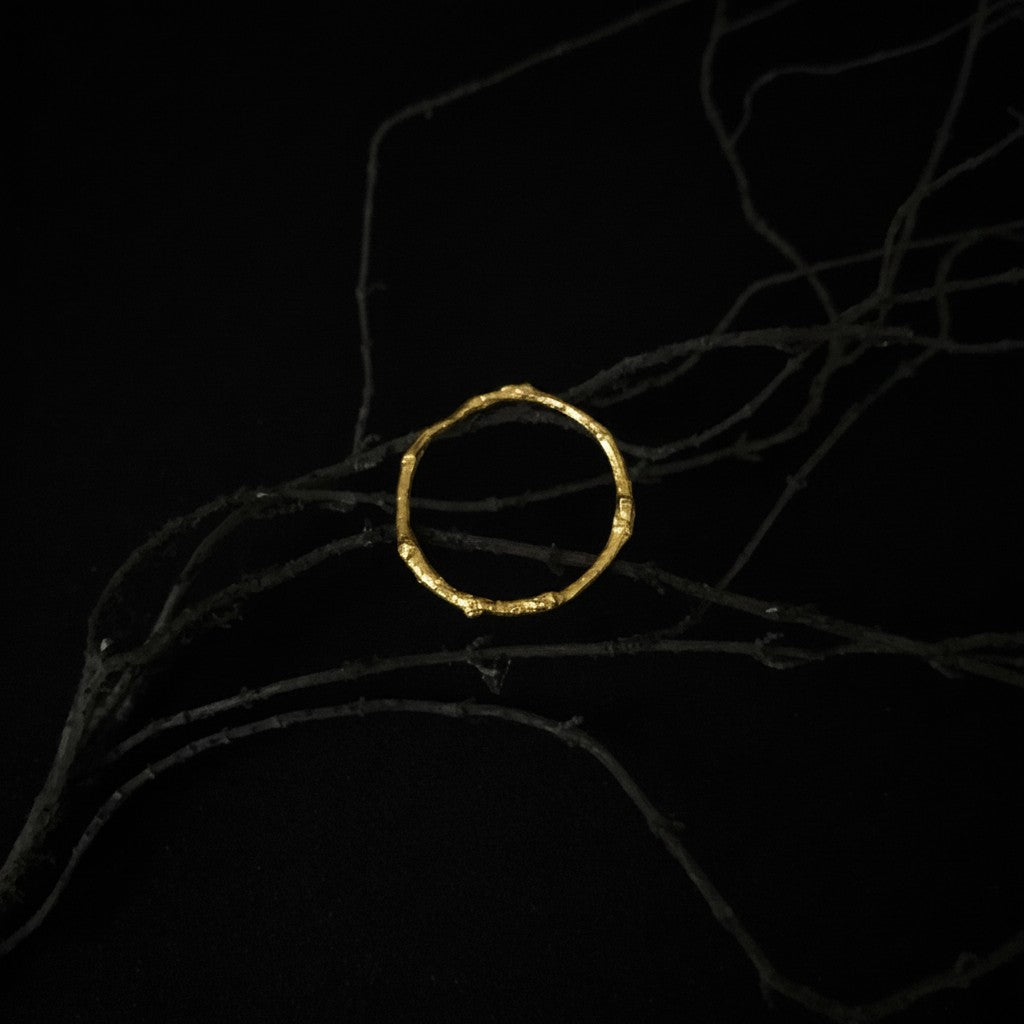 Anello Rametto MandalaT in oro con texture naturale a forma di ramo su sfondo nero