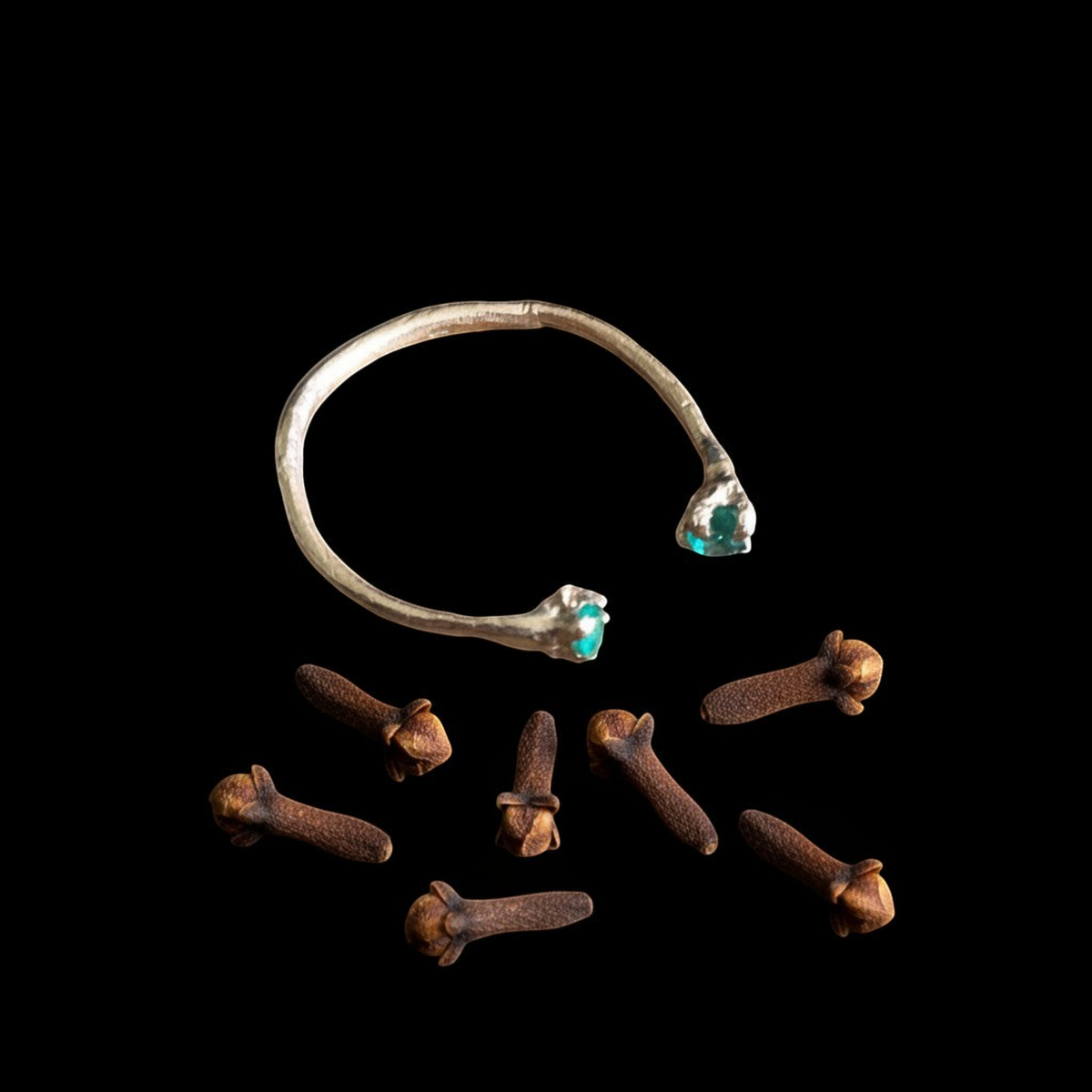 Anello aperto MandalaT in oro con smeraldi, design ispirato ai chiodi di garofano su sfondo nero