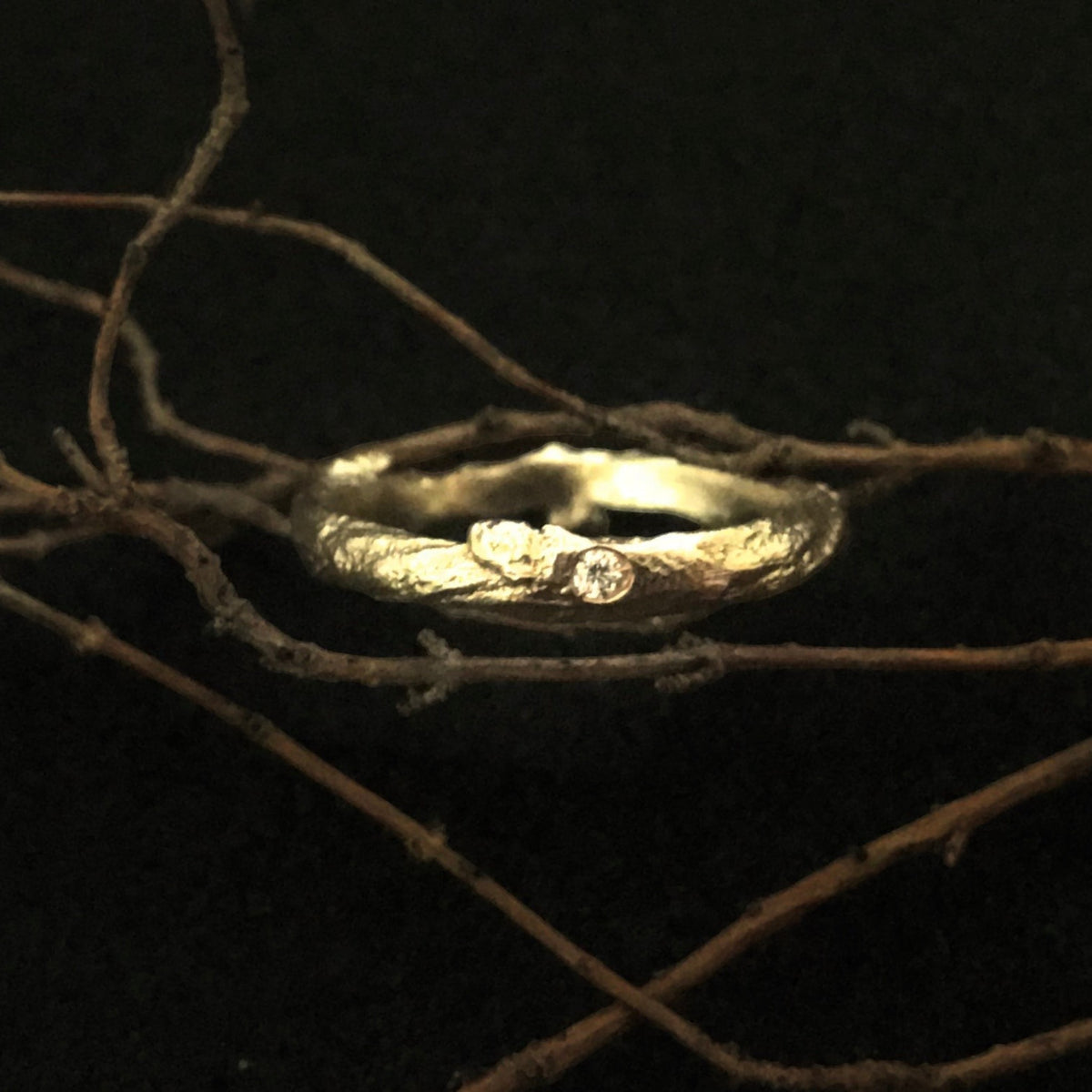 Anello MandalaT a forma di ramo in oro testurizzato con piccolo diamante incastonato su sfondo scuro