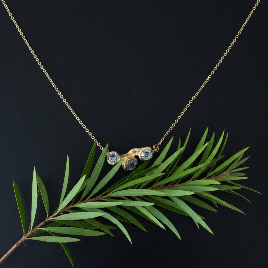 Collana MandalaT Callistemone in oro con tre pietre incastonate ispirate ai fiori, design elegante e naturale