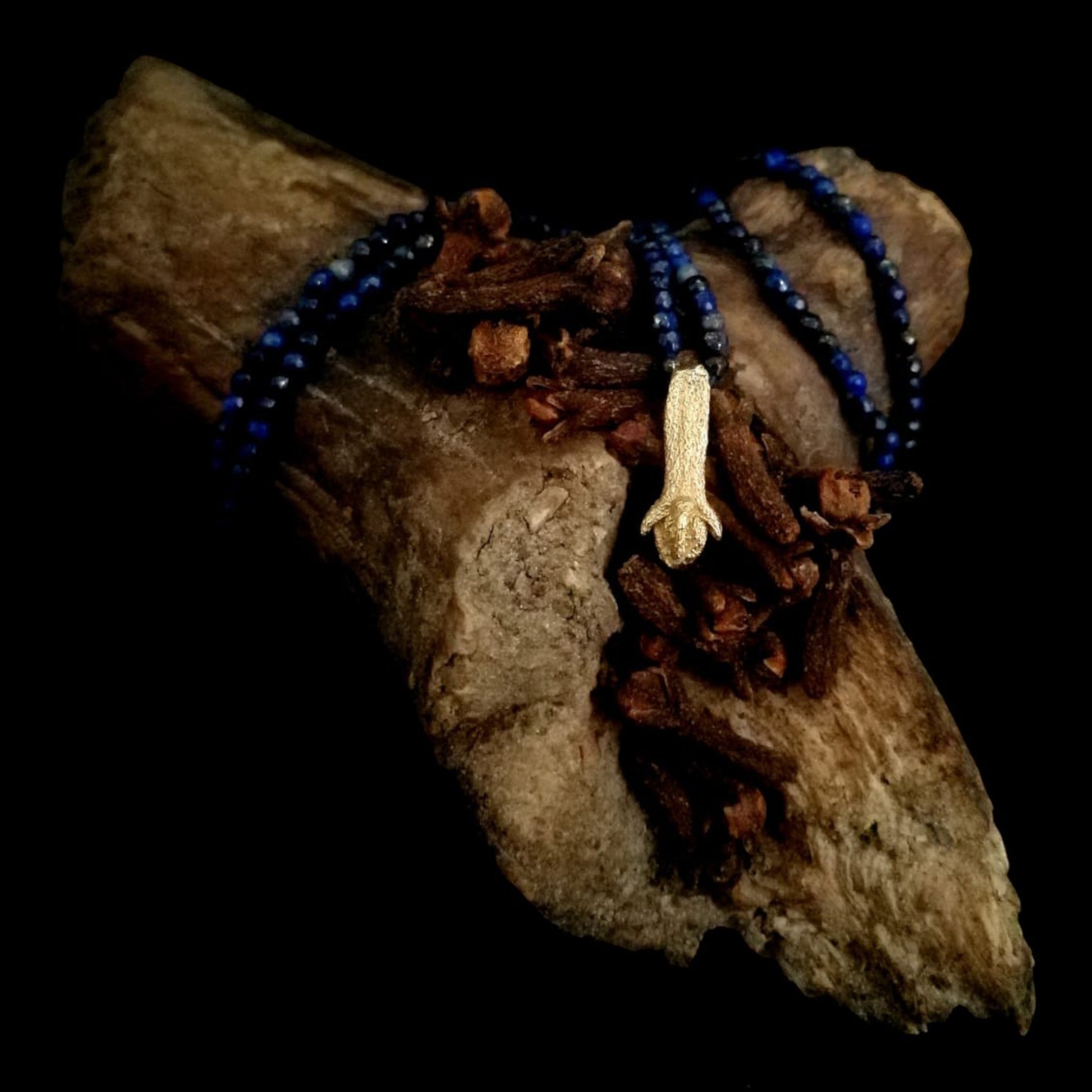 Collana MandalaT con ciondolo a forma di chiodo di garofano dorato e perline in lapislazzuli blu su legno naturale